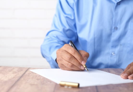 Man signing a piece of paper